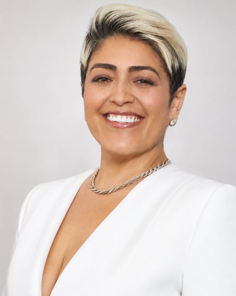 Loren E. Umaña, President of LL Real Estate, smiling in a white blazer